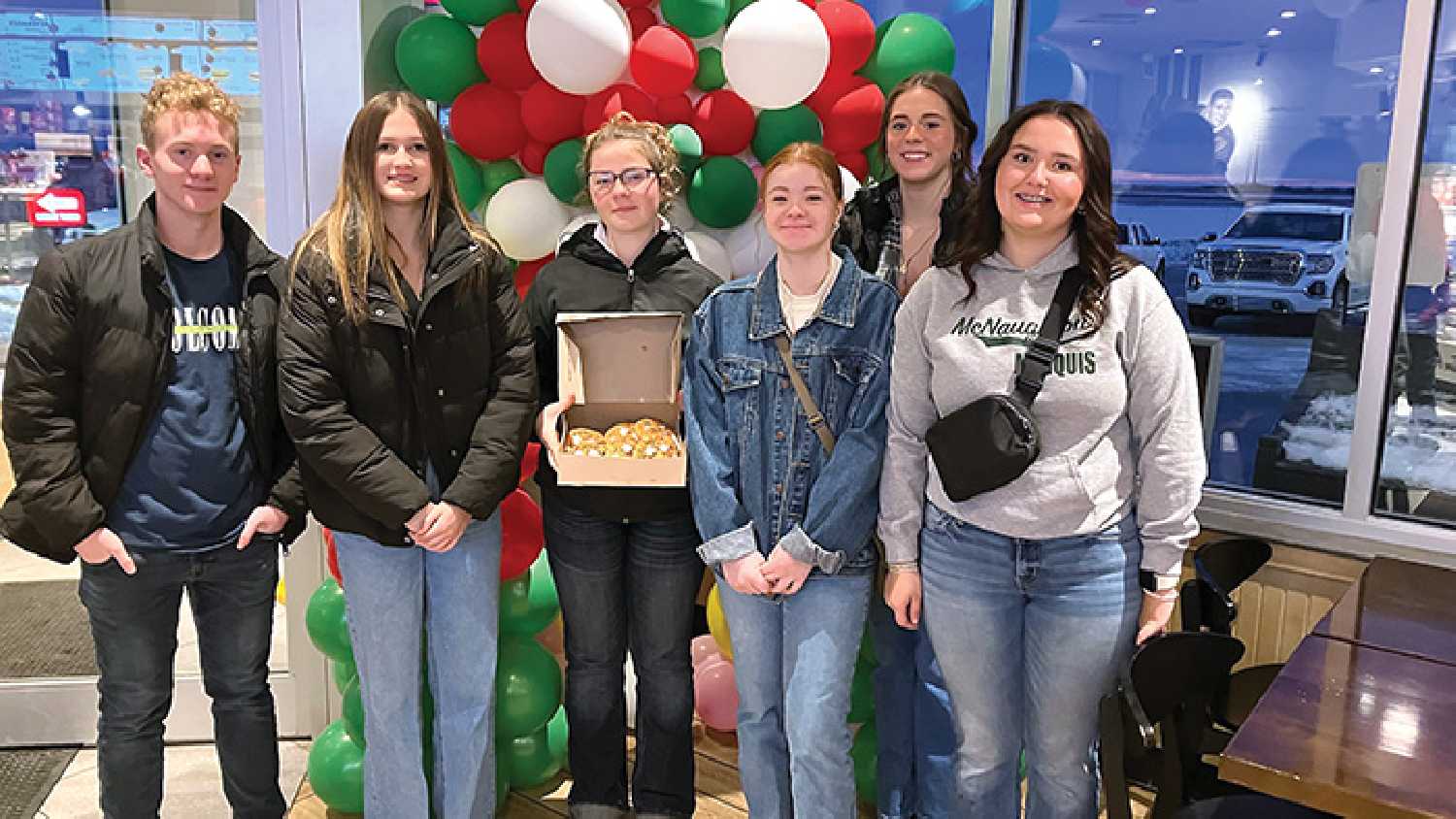 McNaughton High School students decorating Holiday Smile Cookies at Tim Hortons during Holiday Smile Cookie Week.